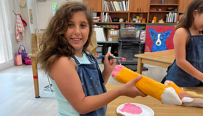 girl painting sculpture