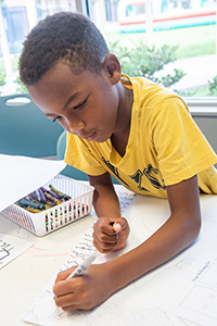 Boy drawing on paper