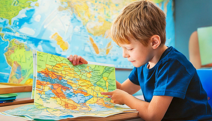 boy looking at maps