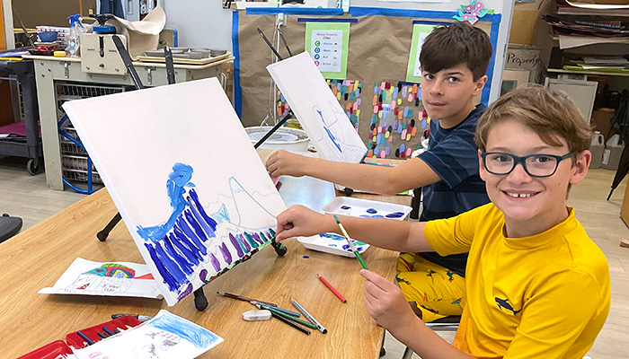 boys painting on canvas