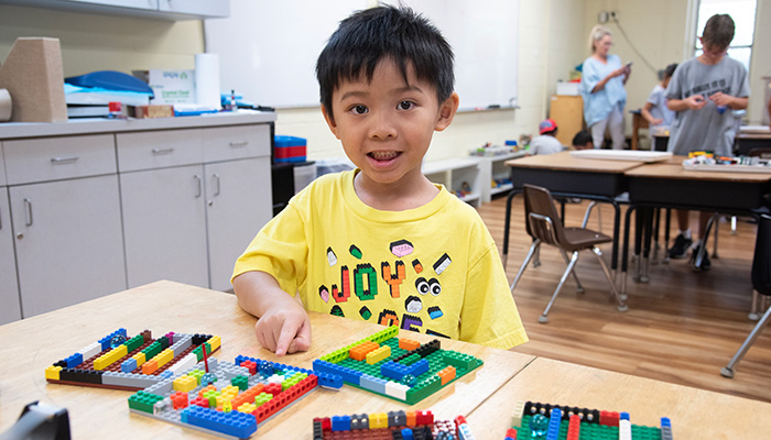 boy playing with legos