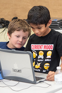 boys collaborating on computer