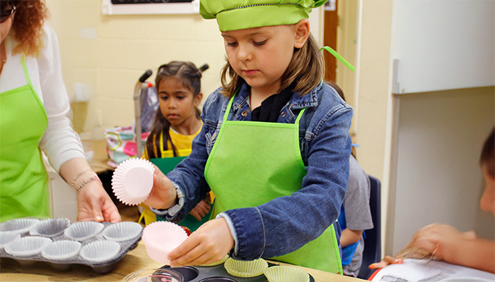 girl making muffins