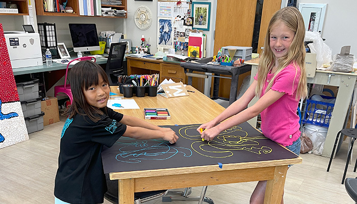 two girls drawing