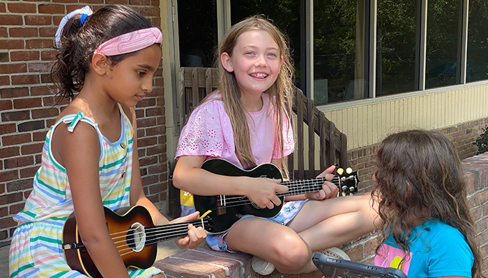 girls playing ukelele